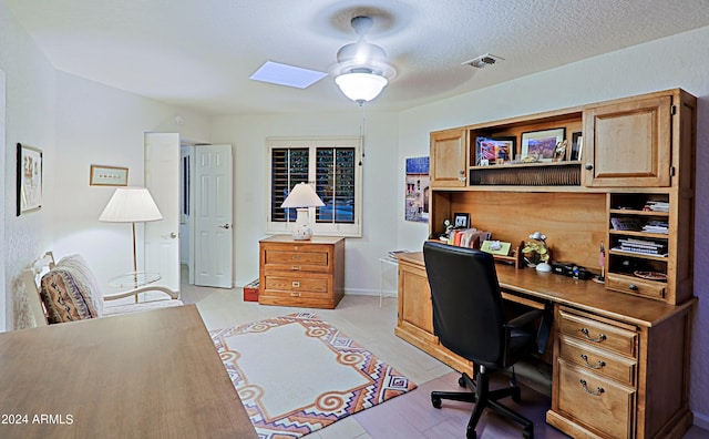 home office featuring a textured ceiling and ceiling fan