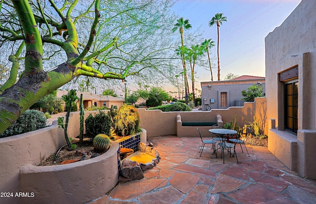 view of patio terrace at dusk