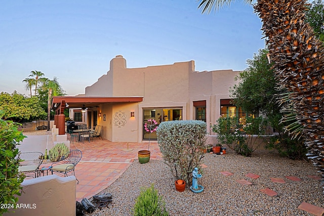 pueblo-style home with a patio