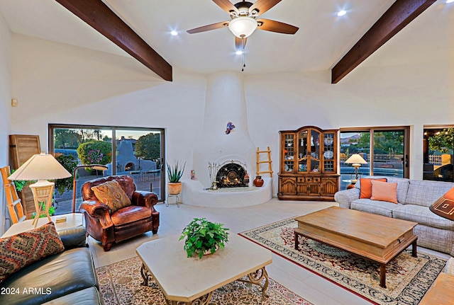 living room featuring a fireplace, a wealth of natural light, and beamed ceiling