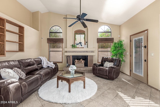 tiled living room featuring ceiling fan and lofted ceiling