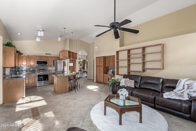 living room with sink, high vaulted ceiling, light tile patterned flooring, and ceiling fan