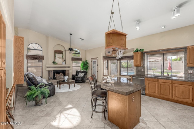 kitchen featuring a breakfast bar area, plenty of natural light, and light tile patterned floors