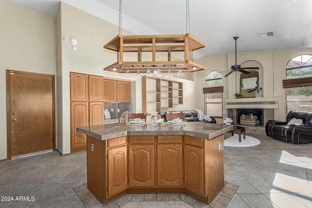 kitchen featuring a center island, ceiling fan, and hanging light fixtures