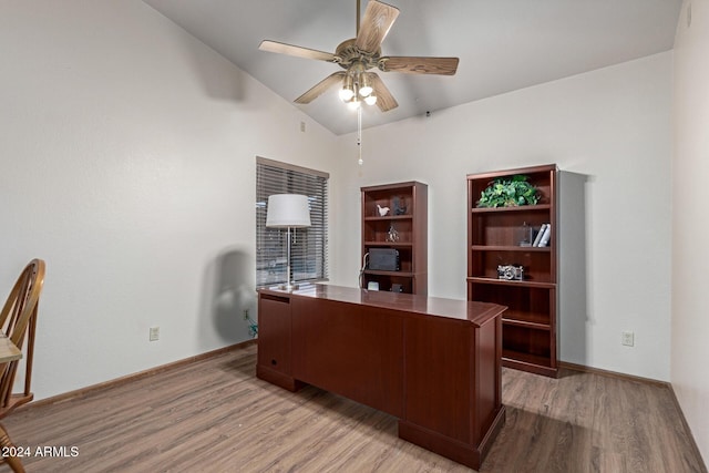 office space featuring ceiling fan, light wood-type flooring, and vaulted ceiling