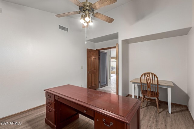 home office with ceiling fan and light hardwood / wood-style flooring