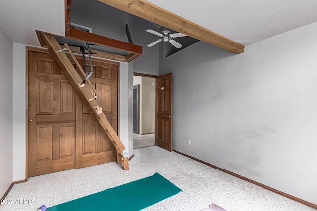 carpeted bedroom featuring beamed ceiling