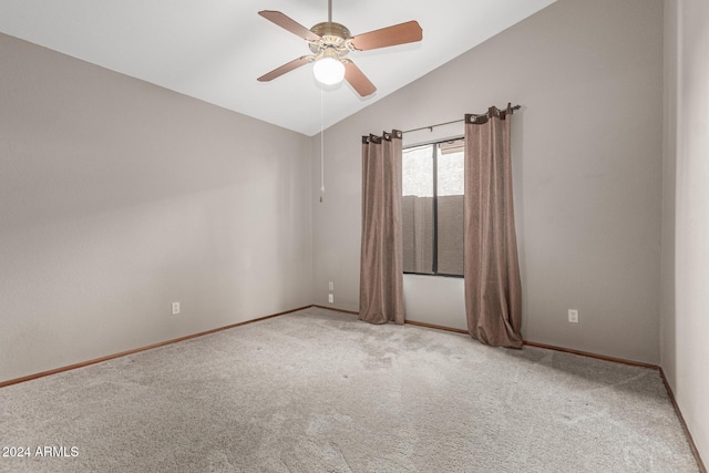 spare room featuring lofted ceiling, ceiling fan, and light colored carpet