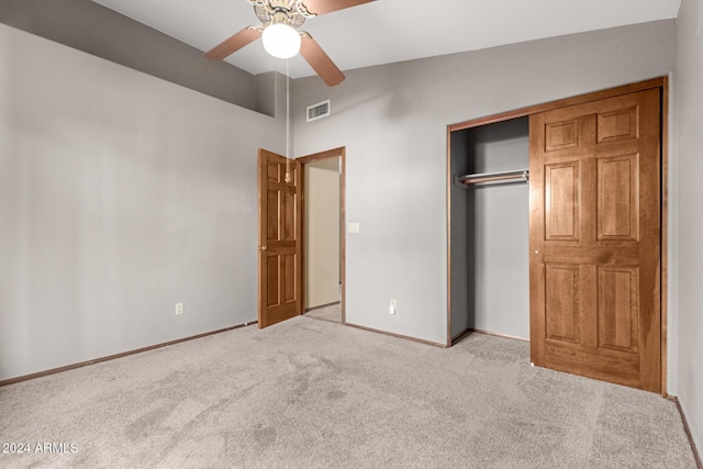 unfurnished bedroom featuring a closet, ceiling fan, and light carpet