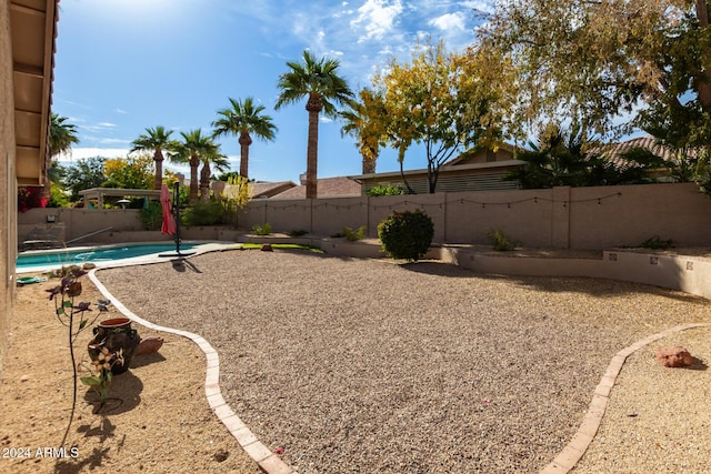 view of yard featuring a fenced in pool