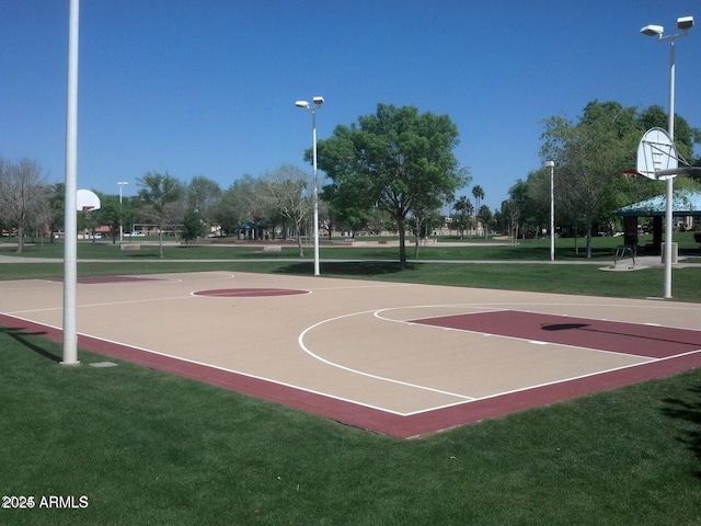 view of basketball court with a lawn