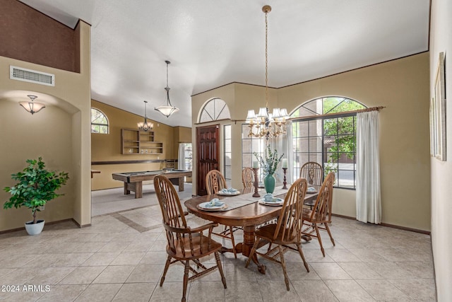 tiled dining room featuring pool table, a chandelier, vaulted ceiling, and plenty of natural light