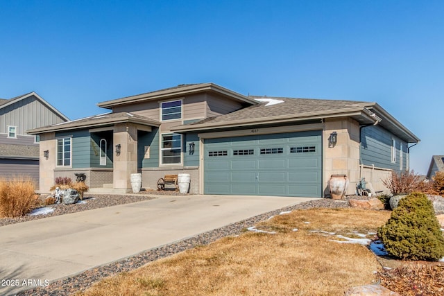 prairie-style home with driveway, brick siding, roof with shingles, and an attached garage