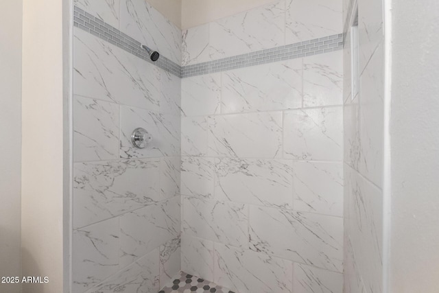 bathroom with tiled shower