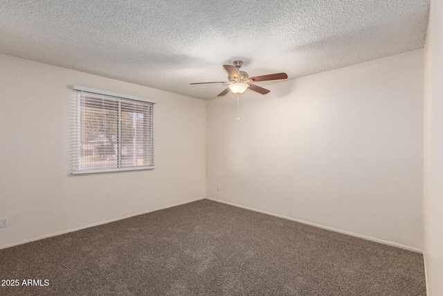 unfurnished room featuring a textured ceiling, dark carpet, and a ceiling fan