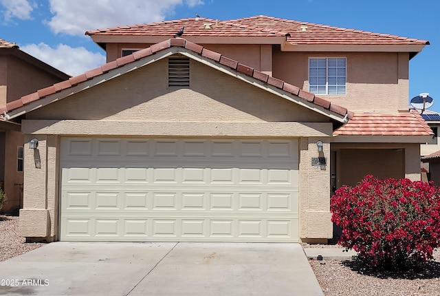 view of front of house with a tile roof, driveway, a garage, and stucco siding