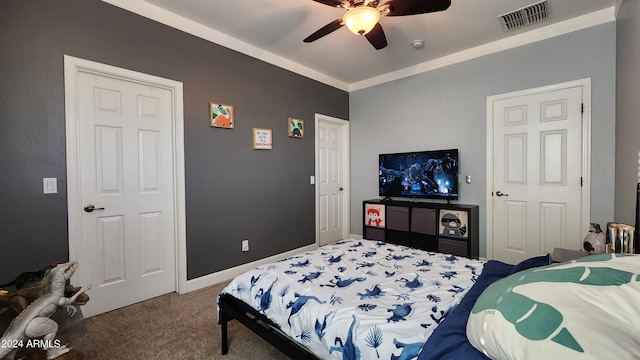 carpeted bedroom with ceiling fan, baseboards, visible vents, and crown molding