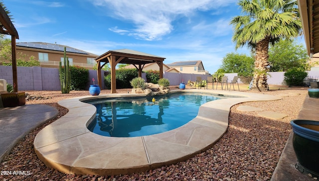 view of swimming pool with a fenced in pool, a fenced backyard, and a gazebo