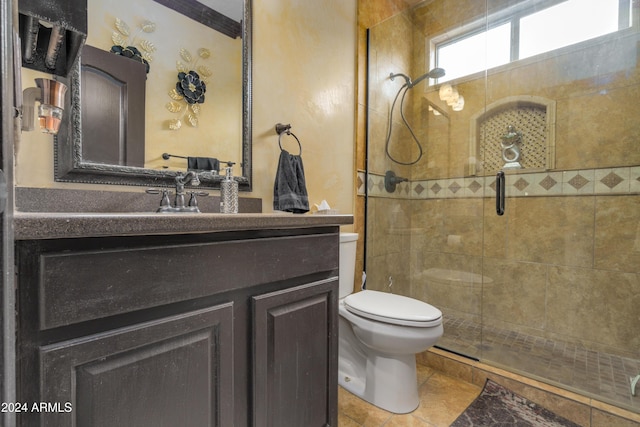 bathroom with tile patterned floors, vanity, an enclosed shower, and toilet