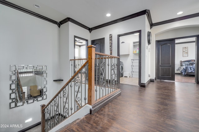 interior space featuring washer / dryer, dark hardwood / wood-style floors, and ornamental molding