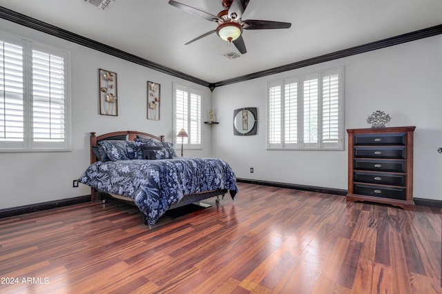 bedroom featuring multiple windows, dark wood-type flooring, ceiling fan, and crown molding