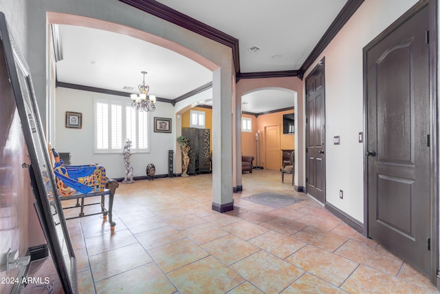 entrance foyer featuring a chandelier and ornamental molding