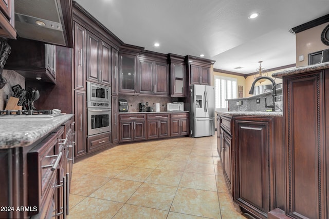 kitchen with decorative backsplash, dark brown cabinetry, stainless steel appliances, and crown molding