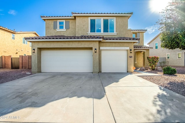 mediterranean / spanish-style home with a garage