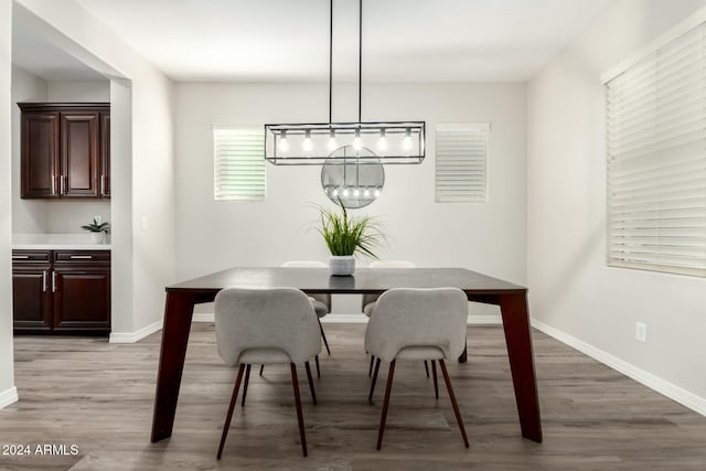 dining space featuring an inviting chandelier and hardwood / wood-style flooring