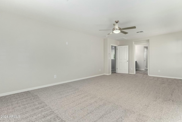 carpeted spare room with ceiling fan