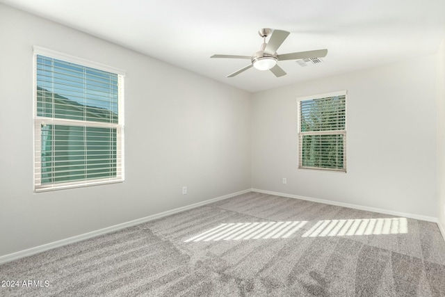 carpeted empty room featuring ceiling fan