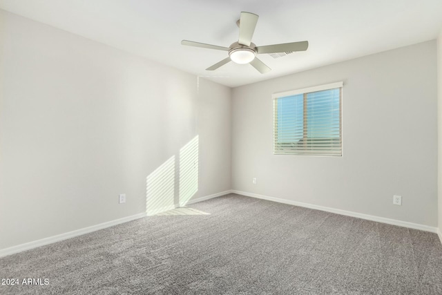 empty room featuring ceiling fan and carpet floors