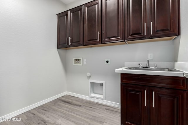 laundry room featuring sink, cabinets, washer hookup, electric dryer hookup, and light hardwood / wood-style flooring