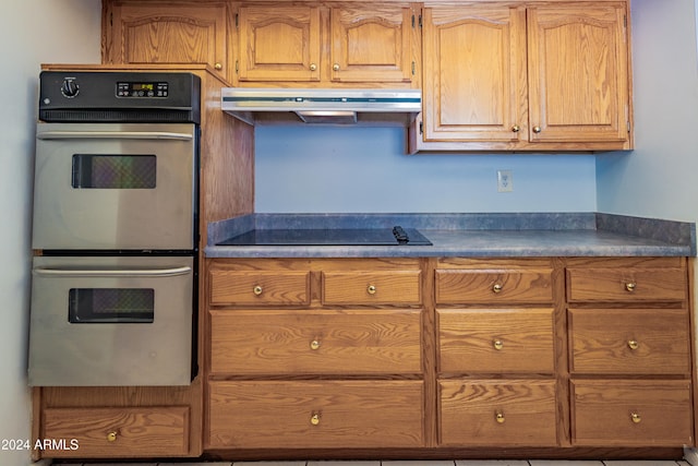 kitchen featuring black electric cooktop and double oven