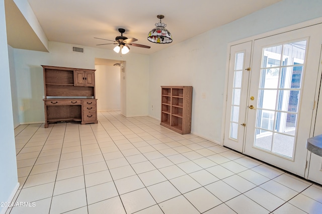 interior space with light tile patterned floors and ceiling fan