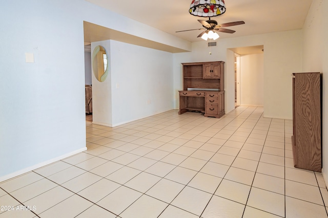 tiled spare room featuring ceiling fan