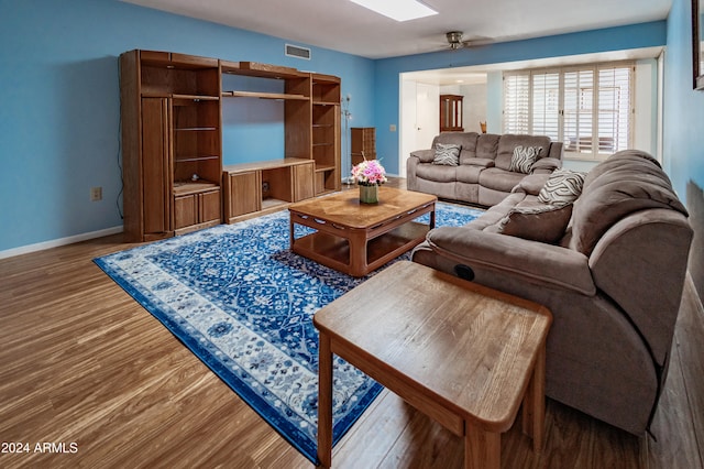 living room with hardwood / wood-style floors and ceiling fan