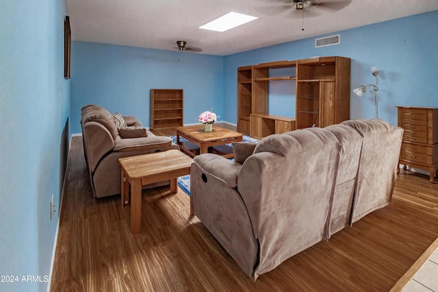 living room with hardwood / wood-style floors and ceiling fan