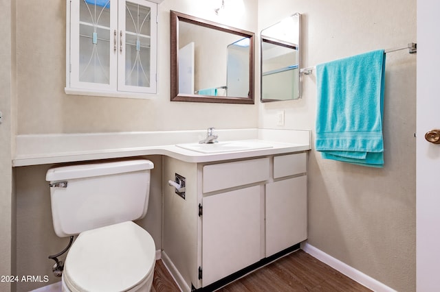 bathroom featuring vanity, toilet, and wood-type flooring