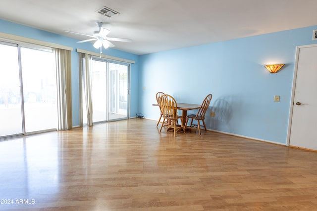 dining space with ceiling fan and light hardwood / wood-style flooring