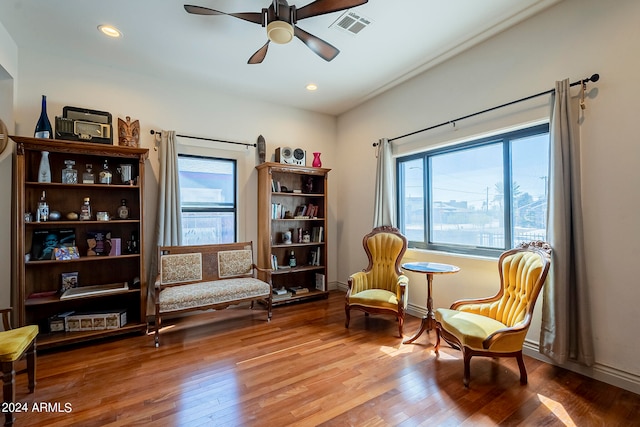 sitting room with ceiling fan and hardwood / wood-style flooring