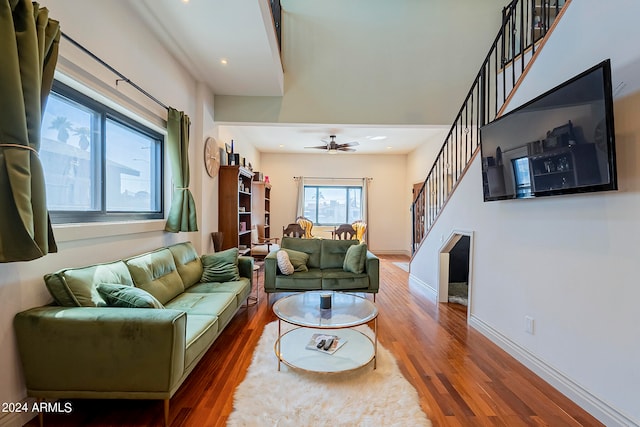 living room featuring ceiling fan and hardwood / wood-style floors