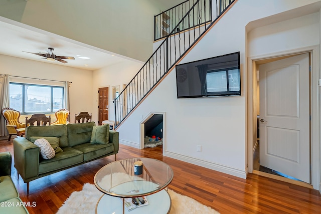 living room featuring ceiling fan and hardwood / wood-style flooring