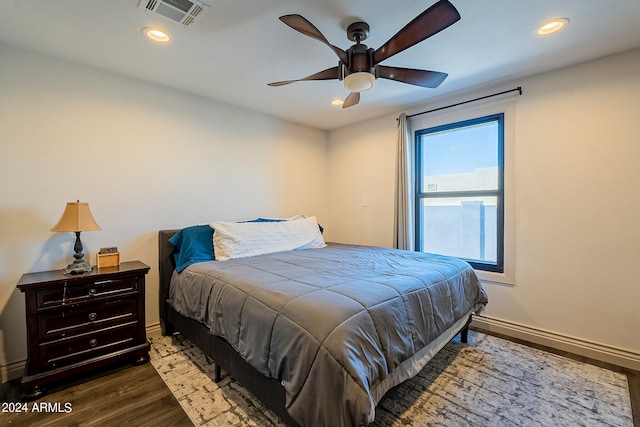 bedroom with ceiling fan and dark hardwood / wood-style flooring