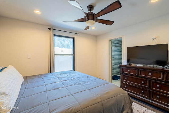 bedroom featuring ceiling fan, light wood-type flooring, a closet, and a walk in closet