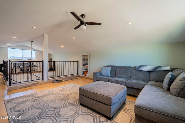 living room featuring light hardwood / wood-style flooring, lofted ceiling, and ceiling fan