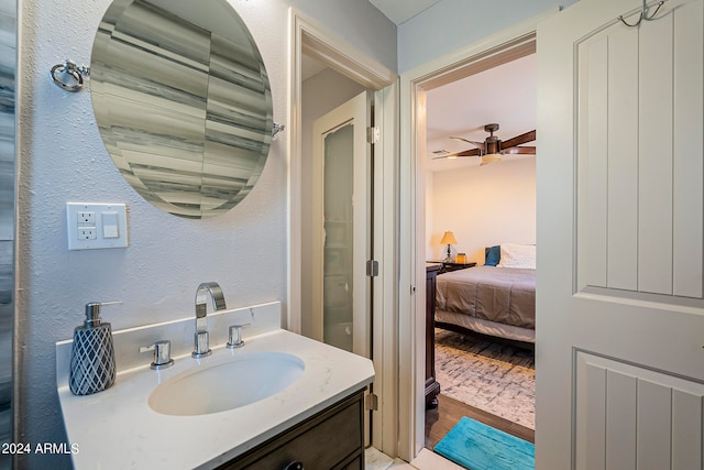 bathroom with wood-type flooring, ceiling fan, and vanity