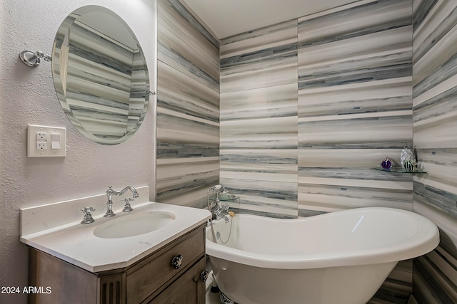 bathroom with tile walls, vanity, and a bathing tub