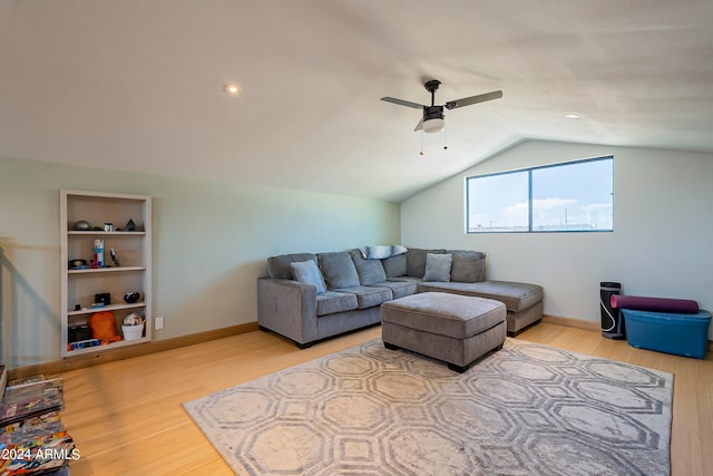 living room with wood-type flooring, vaulted ceiling, and ceiling fan