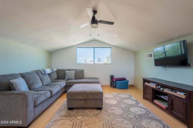 living room featuring lofted ceiling, ceiling fan, and light hardwood / wood-style flooring